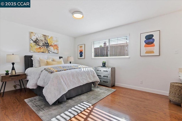 bedroom with hardwood / wood-style floors