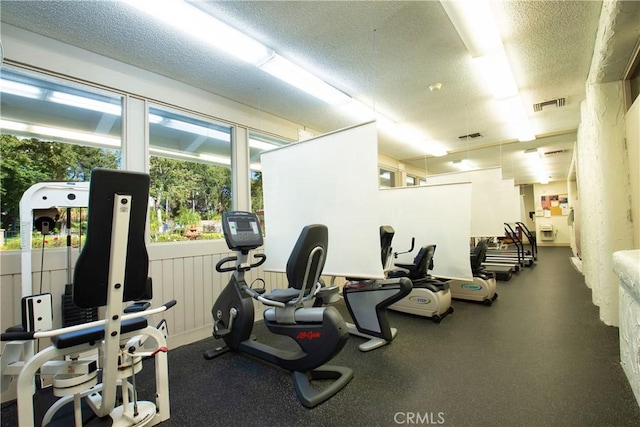 exercise room with a textured ceiling