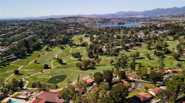 birds eye view of property with view of golf course and a water and mountain view