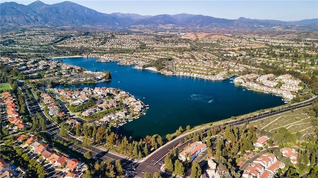 birds eye view of property with a water and mountain view