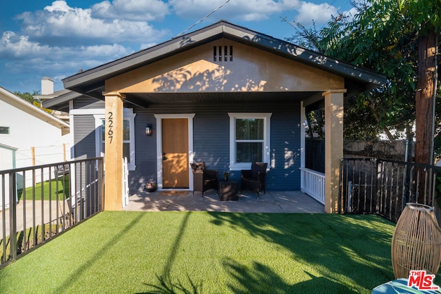 view of front of property with a front lawn and a patio