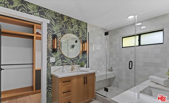 bathroom featuring vanity, a shower with door, and hardwood / wood-style floors