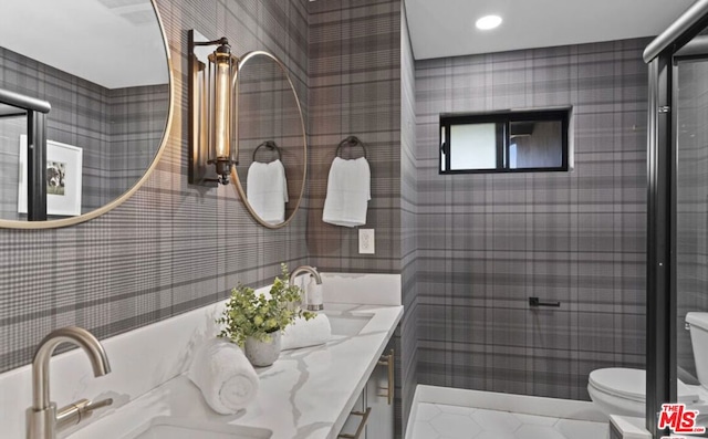 bathroom featuring walk in shower, tile patterned floors, vanity, and toilet