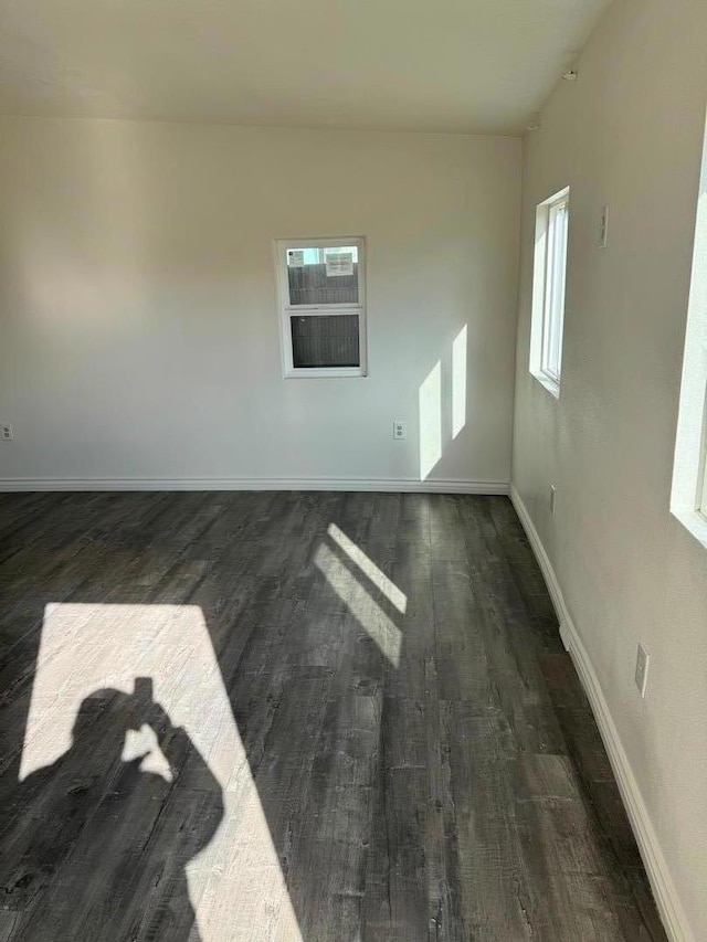 empty room with dark wood-type flooring