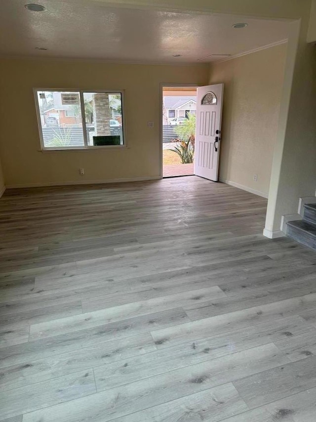 foyer featuring crown molding and light hardwood / wood-style flooring