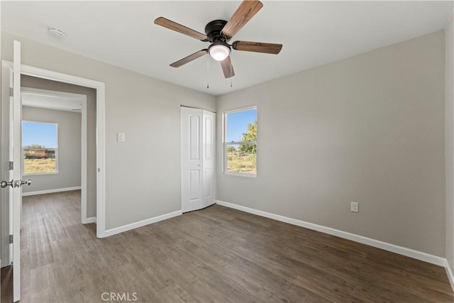 unfurnished bedroom featuring wood-type flooring, ceiling fan, and a closet