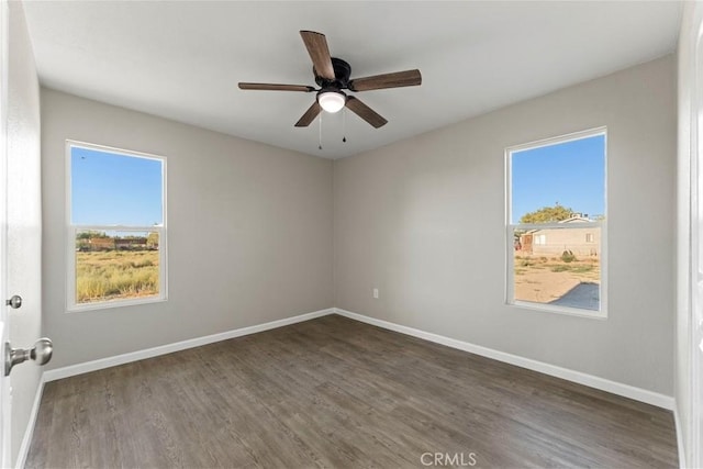 unfurnished room with ceiling fan, plenty of natural light, and dark hardwood / wood-style flooring