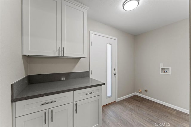 kitchen featuring white cabinets and light hardwood / wood-style flooring