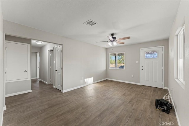 interior space featuring dark wood-type flooring and ceiling fan