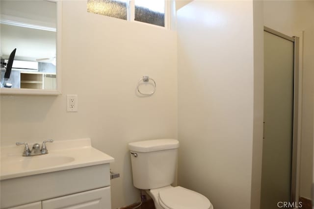 bathroom with vanity, a wall mounted air conditioner, and toilet