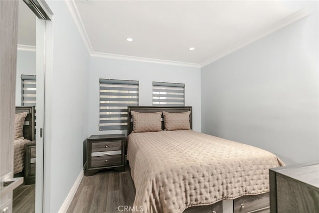 bedroom with ornamental molding and dark hardwood / wood-style flooring