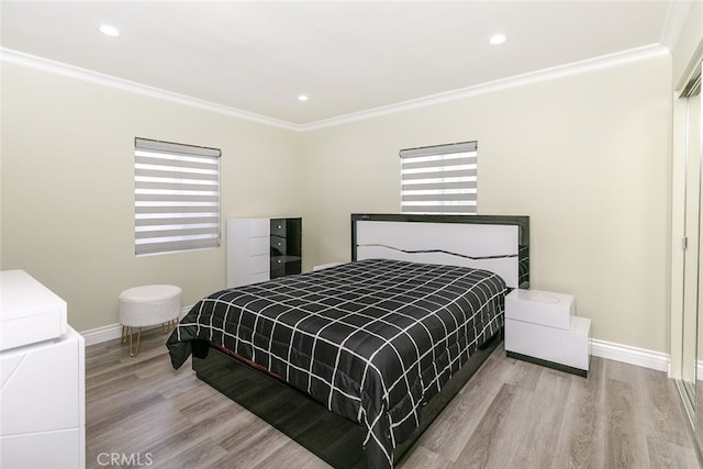 bedroom featuring ornamental molding and light wood-type flooring