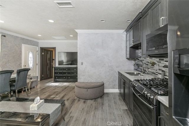 kitchen featuring double oven range, sink, dark wood-type flooring, and ornamental molding