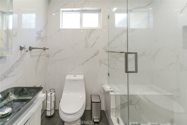 bathroom featuring toilet, an enclosed shower, sink, and tile walls