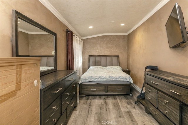 bedroom with crown molding and light hardwood / wood-style floors