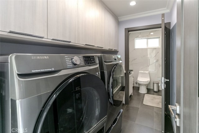 laundry area featuring ornamental molding and washing machine and dryer