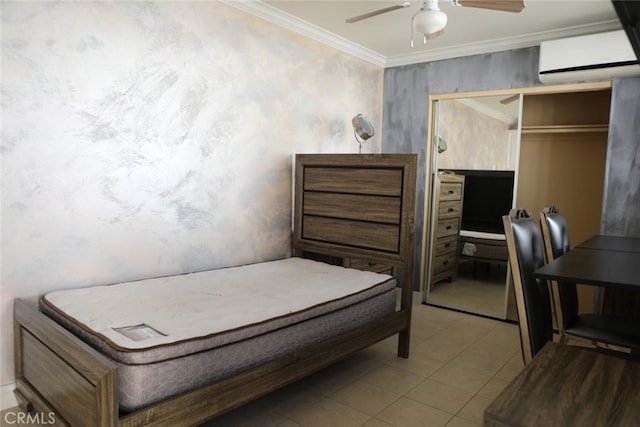 bedroom featuring a wall mounted AC, ornamental molding, a closet, ceiling fan, and tile patterned flooring