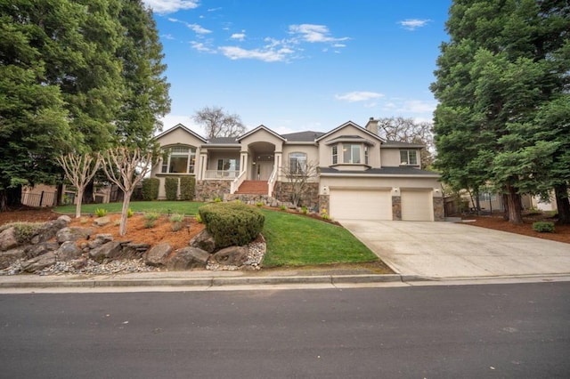 view of front of property with a garage and a front yard