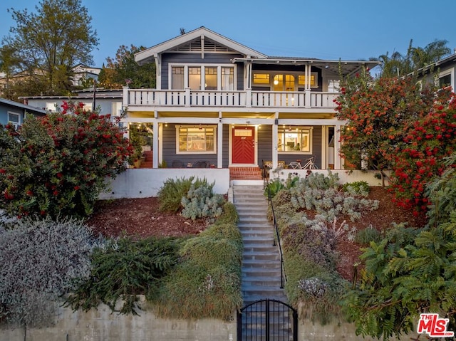 view of front of home with a balcony and a porch