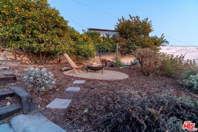 view of yard with a fire pit