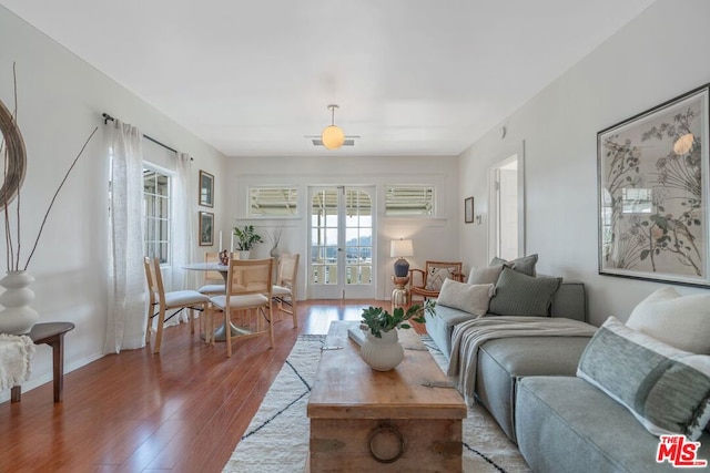 living room with wood-type flooring and french doors