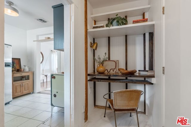 hallway featuring light tile patterned floors