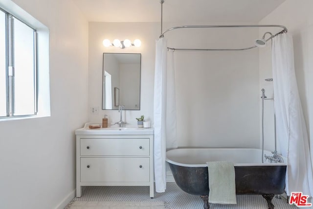 bathroom featuring vanity and shower / tub combo with curtain