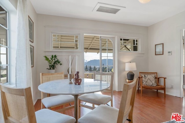 dining area with wood-type flooring and a mountain view