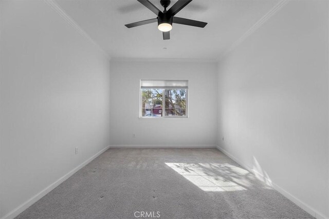 carpeted empty room with ornamental molding and ceiling fan