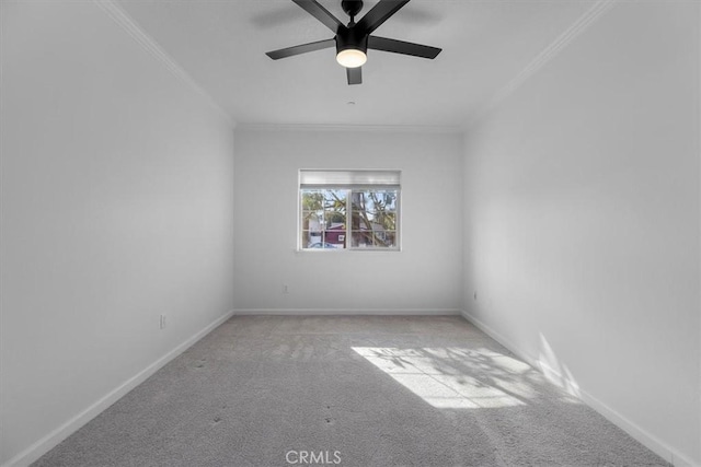 spare room with ceiling fan, light colored carpet, and ornamental molding