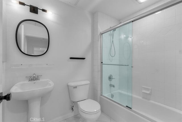 full bathroom with enclosed tub / shower combo, sink, and toilet