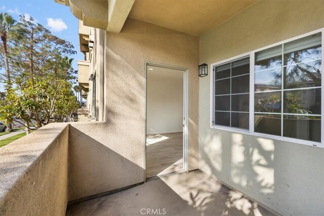 view of exterior entry with a balcony