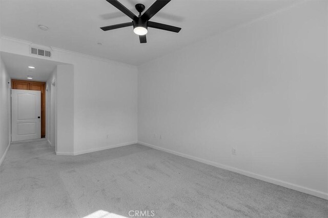 carpeted empty room featuring ornamental molding and ceiling fan