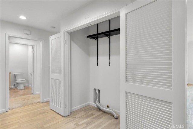 laundry room with light hardwood / wood-style flooring