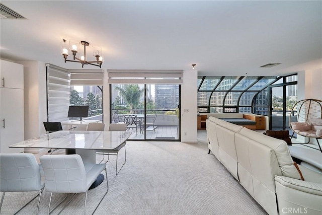 carpeted living room featuring an inviting chandelier and floor to ceiling windows