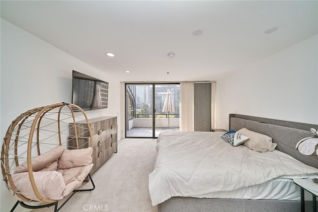 carpeted bedroom with access to exterior and a wall of windows