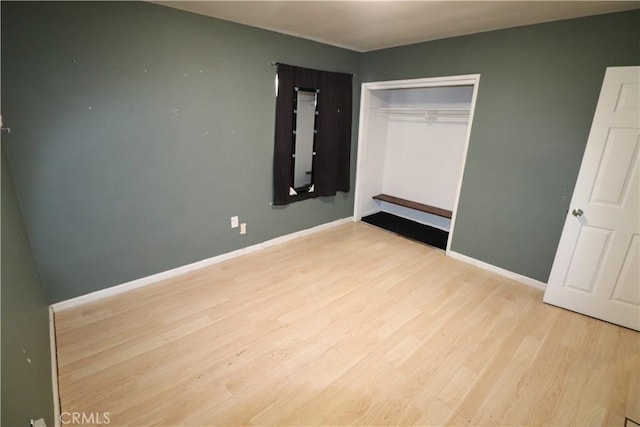 unfurnished bedroom with light hardwood / wood-style floors and a closet