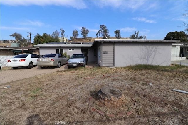 ranch-style home with solar panels