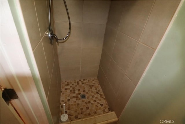 bathroom with tiled shower