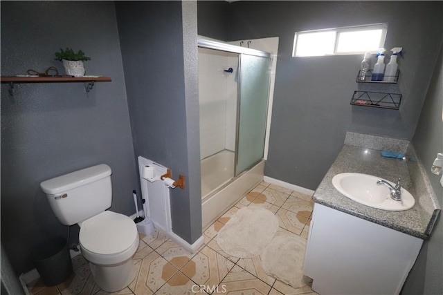 full bathroom featuring vanity, toilet, tile patterned flooring, and combined bath / shower with glass door