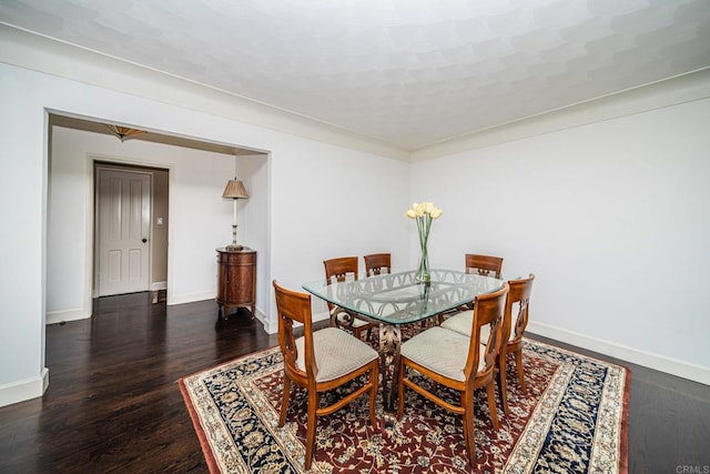 dining area with dark hardwood / wood-style floors