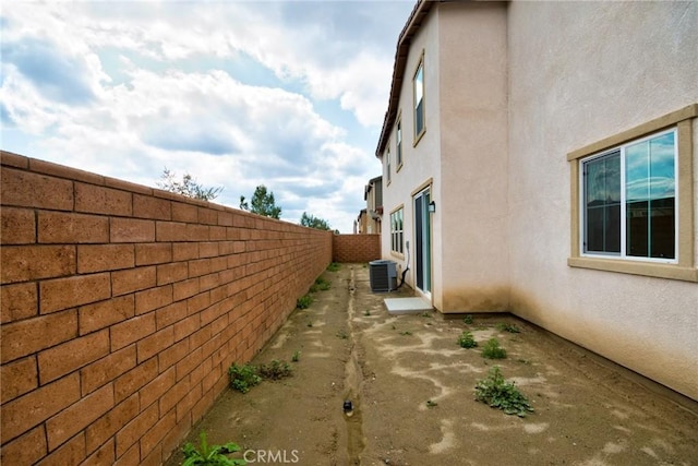 view of side of home with central air condition unit