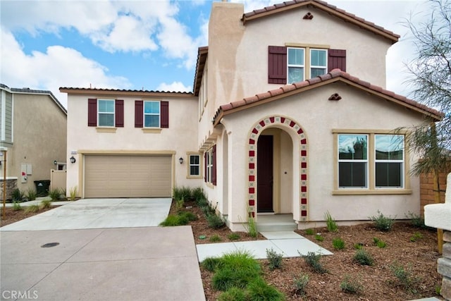 mediterranean / spanish house featuring a garage