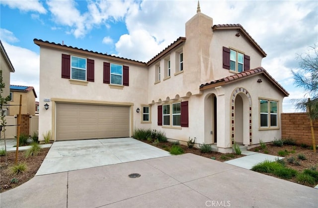 mediterranean / spanish-style house with a garage