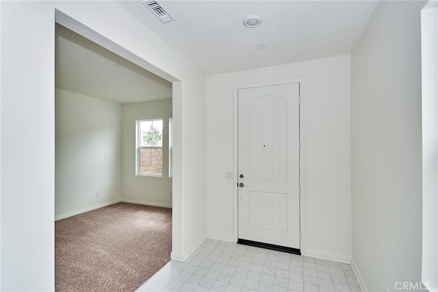 view of carpeted foyer