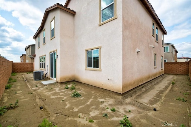 rear view of property featuring cooling unit