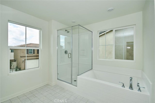 bathroom with shower with separate bathtub