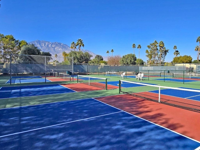 view of sport court featuring basketball hoop and a mountain view