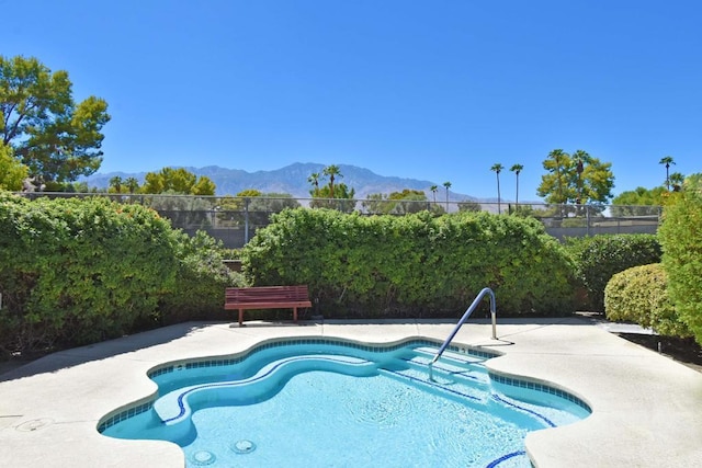 view of pool with a mountain view and a patio area