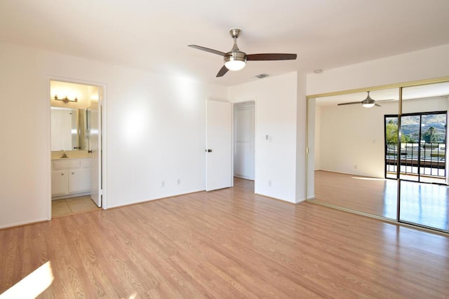 unfurnished bedroom featuring connected bathroom, light hardwood / wood-style flooring, a closet, and ceiling fan